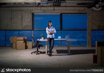portrait of young female architect on construction site checking documents and business workflow using laptop computer in new startup office