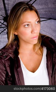 portrait of young female carrying umbrella against white background