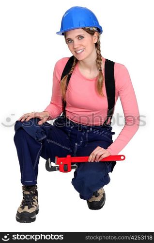 portrait of young female electrician holding spanner