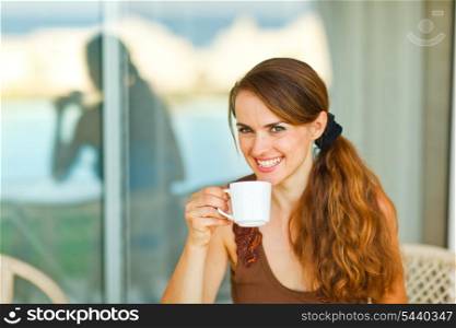 Portrait of young female having cup of coffee&#xA;