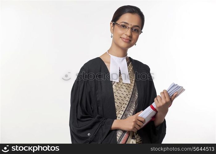 Portrait of young female lawyer holding documents isolated over white background
