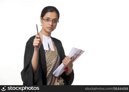 Portrait of young female lawyer holding pen and documents isolated over white background