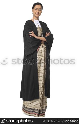 Portrait of young female lawyer standing with arms crossed isolated over white background