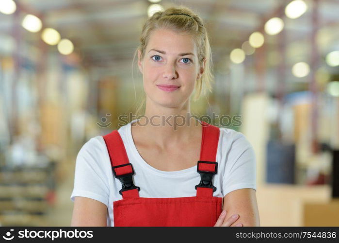 portrait of young female mechanic in a store