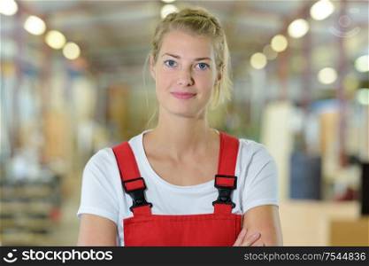 portrait of young female mechanic in a store