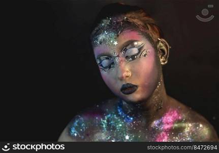 Portrait of young female model with creative makeup,  rhinestones and piercing. Creative make-up of a girl with rhinestones and piercing