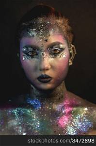 Portrait of young female model with creative makeup,  rhinestones and piercing. Creative make-up of a girl with rhinestones and piercing