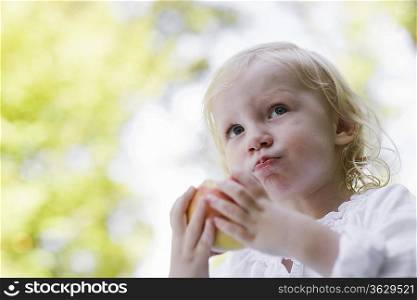 Portrait of young girl 91-2) eating apple