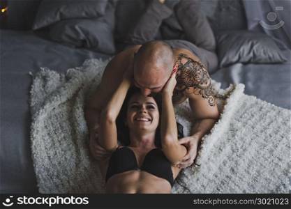 Portrait of young girl and guy in the room in his underwear.. A young couple in underwear lying under the bed 178.