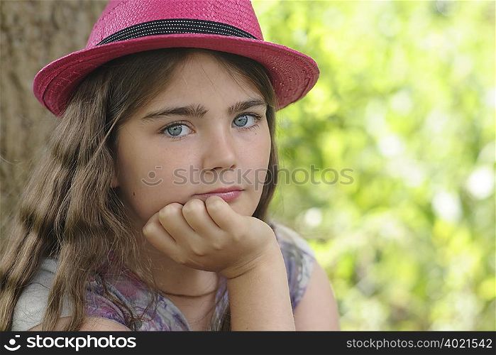 Portrait of young girl in pink hat