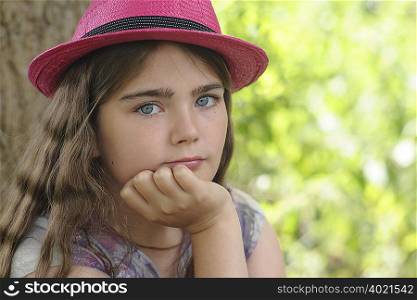Portrait of young girl in pink hat
