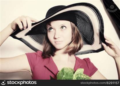Portrait of young girl in summer hat closeup