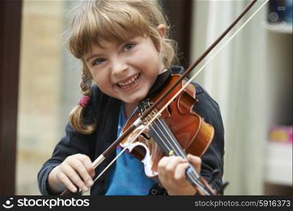 Portrait Of Young Girl Learning To Play Violin