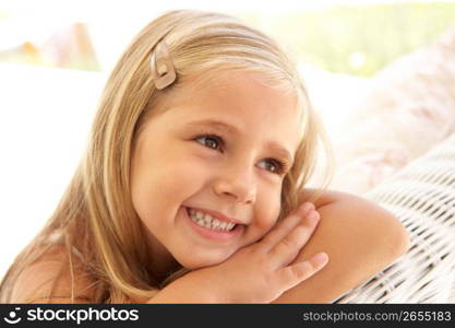 Portrait Of Young Girl Relaxing On Sofa