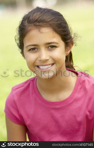 Portrait Of Young Girl Sitting In Park