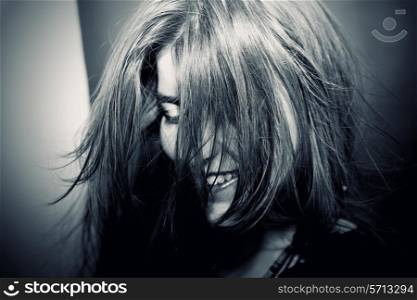Portrait of Young girl with hair fluttering in wind closeup