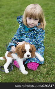 Portrait Of Young Girl With Pet King Charles Spaniel Dog