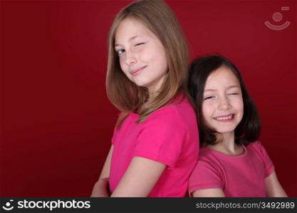 Portrait of young girls on red background