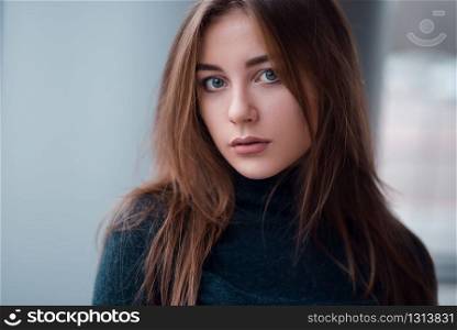 Portrait of young glamour woman with long beautiful hair on blur background.. Portrait close up of glamour woman with long hair.