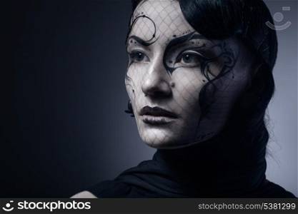 portrait of young gothic woman isolated on dark background with copyspace