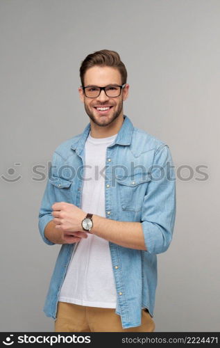 Portrait of young handsome caucasian man in jeans shirt over light background.. Portrait of young handsome caucasian man in jeans shirt over light background