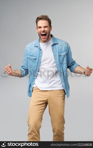 Portrait of young handsome caucasian man in jeans shirt over light background.. Portrait of young handsome caucasian man in jeans shirt over light background