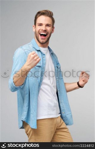 Portrait of young handsome caucasian man in jeans shirt over light background.. Portrait of young handsome caucasian man in jeans shirt over light background