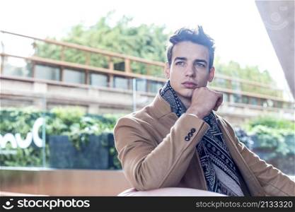 Portrait of young handsome man relaxing outside