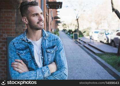 Portrait of young handsome man wearing casual clothes outdoors in the street. Urban concept.