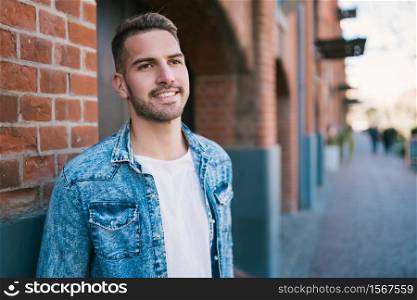 Portrait of young handsome man wearing casual clothes outdoors in the street. Urban concept.
