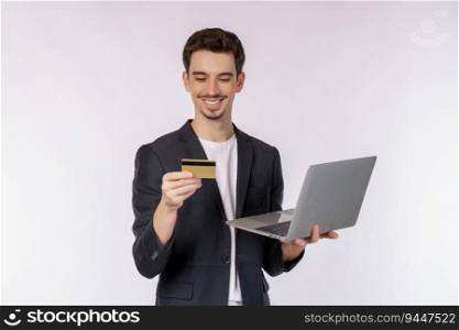 Portrait of young handsome smiling businessman holding creadit card and laptop in hands, typing and browsing web pages isolated on white background. Technology and shopping online concept.