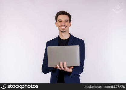 Portrait of young handsome smiling businessman holding laptop in hands, typing and browsing web pages isolated on white background. Technology and business concept.