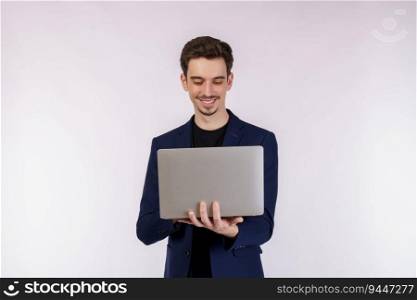 Portrait of young handsome smiling businessman holding laptop in hands, typing and browsing web pages isolated on white background. Technology and business concept.