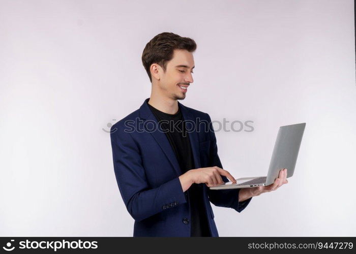 Portrait of young handsome smiling businessman holding laptop in hands, typing and browsing web pages isolated on white background. Technology and business concept.