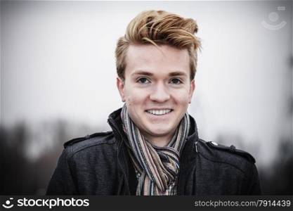 Portrait of young handsome smiling man fashion model casual style on street outdoors