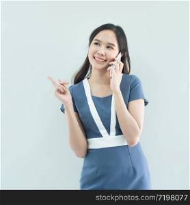 Portrait of young happy asian businesswoman using smart mobile phone isolated over white background in work place.