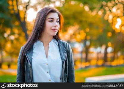 Portrait of young happy business woman in the city. Beautiful caucasian student girl in white sexy blouse standing in the autumn street. Portrait of young happy business woman in the city. Beautiful caucasian student girl in white sexy blouse standing in the autumn street.