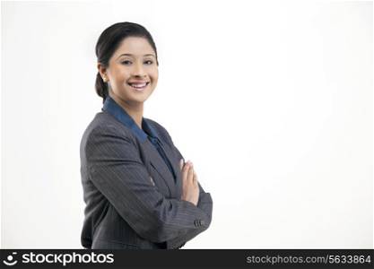 Portrait of young happy businesswoman in suit isolated over gray background