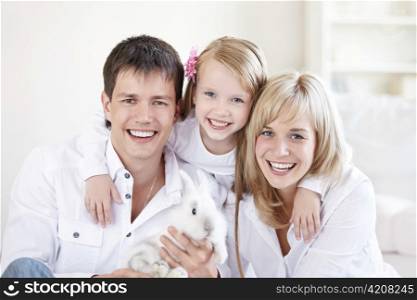 Portrait of young happy family at home