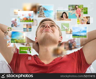 Portrait of young happy man sharing his travel photo and video files in social media