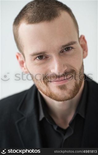 Portrait of young happy smiling business man, isolated over white background, natural light