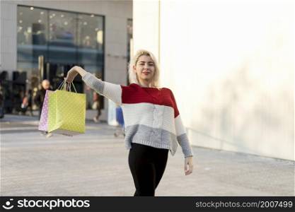 Portrait of young happy smiling woman with shopping bags. Portrait of a young happy smiling woman with shopping bags
