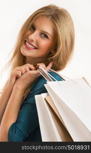 Portrait of young happy smiling woman with shopping bags, isolated over white background