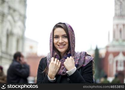 Portrait of young happy woman in red scarf