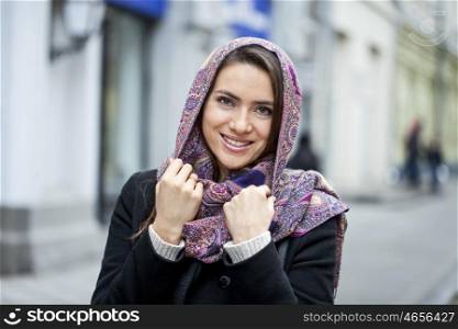 Portrait of young happy woman in red scarf