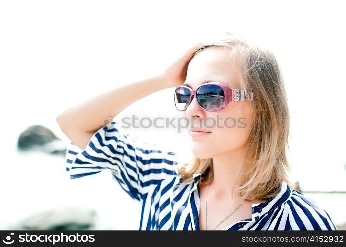 Portrait of young happy woman on a beach