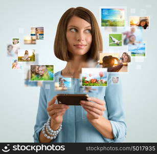 Portrait of young happy woman sharing her photo and video files in social media resources using her modern smartphone