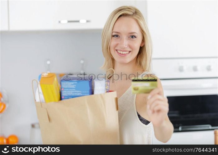 portrait of young happy woman showing credit card