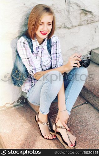 Portrait of young hipster girl making photo with vintage camera. Modern youth lifestyle concept. Lovely face.