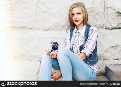 Portrait of young hipster girl making photo with vintage camera. Modern youth lifestyle concept. Lovely face.